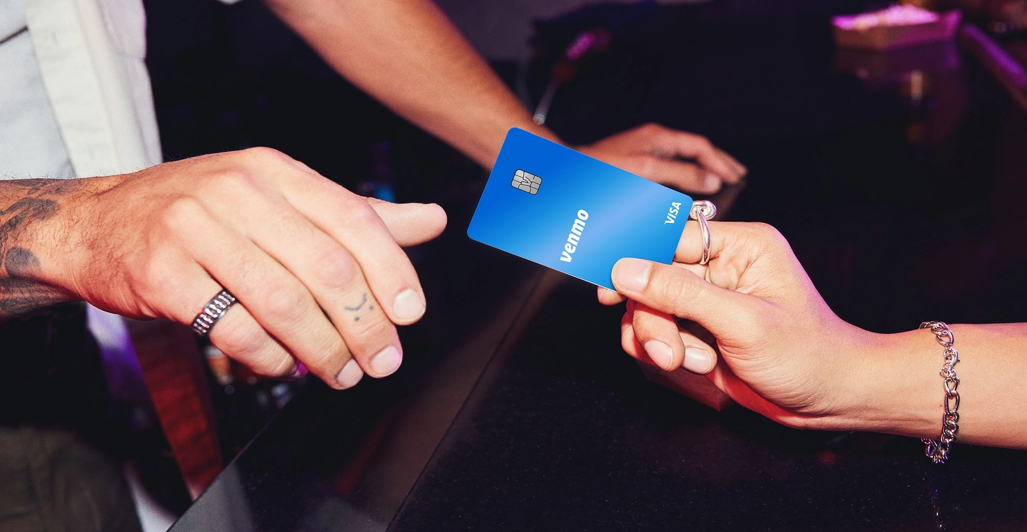 handing a Venmo cedit card