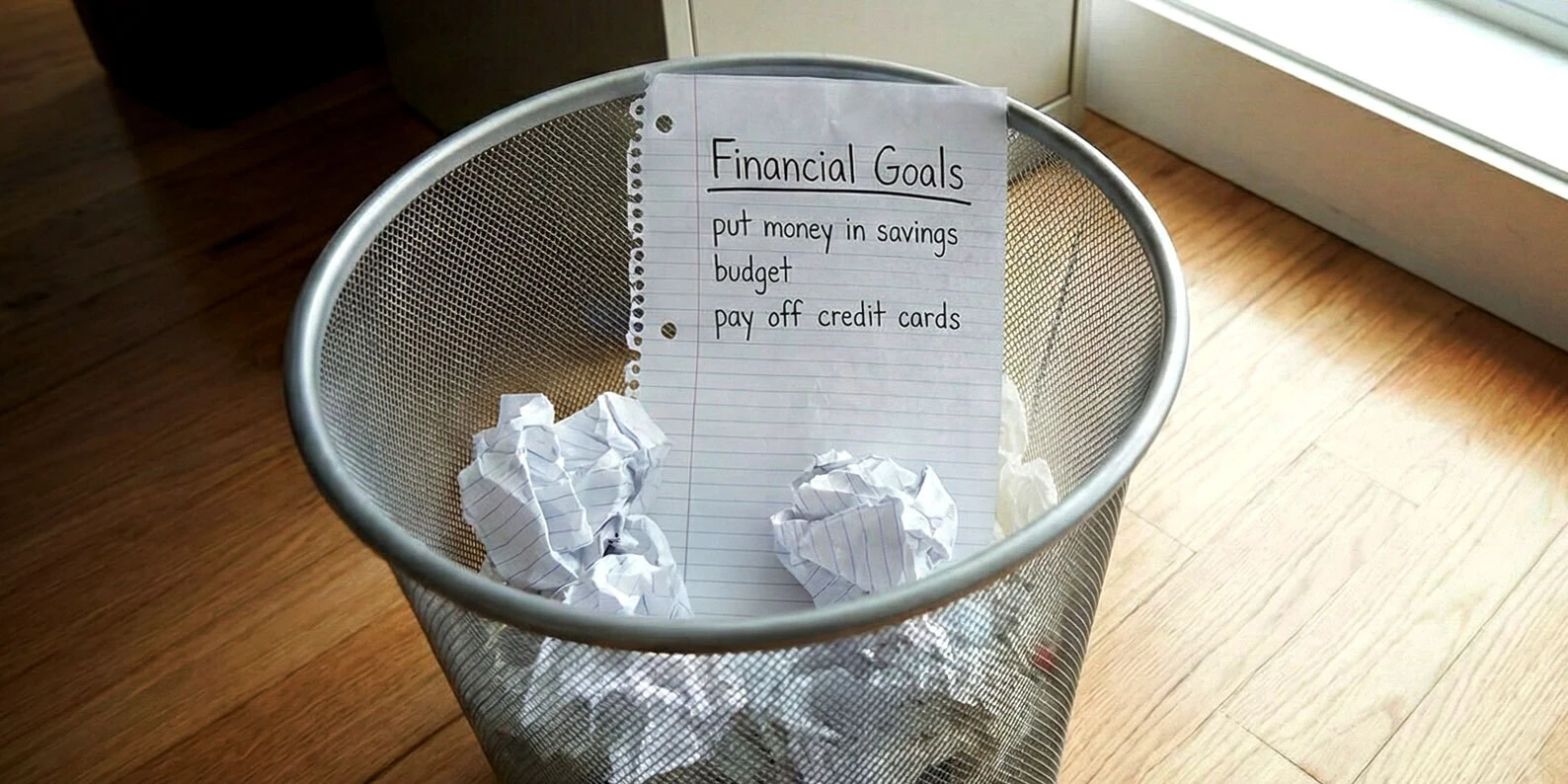 Financial Goals list in a trash can
