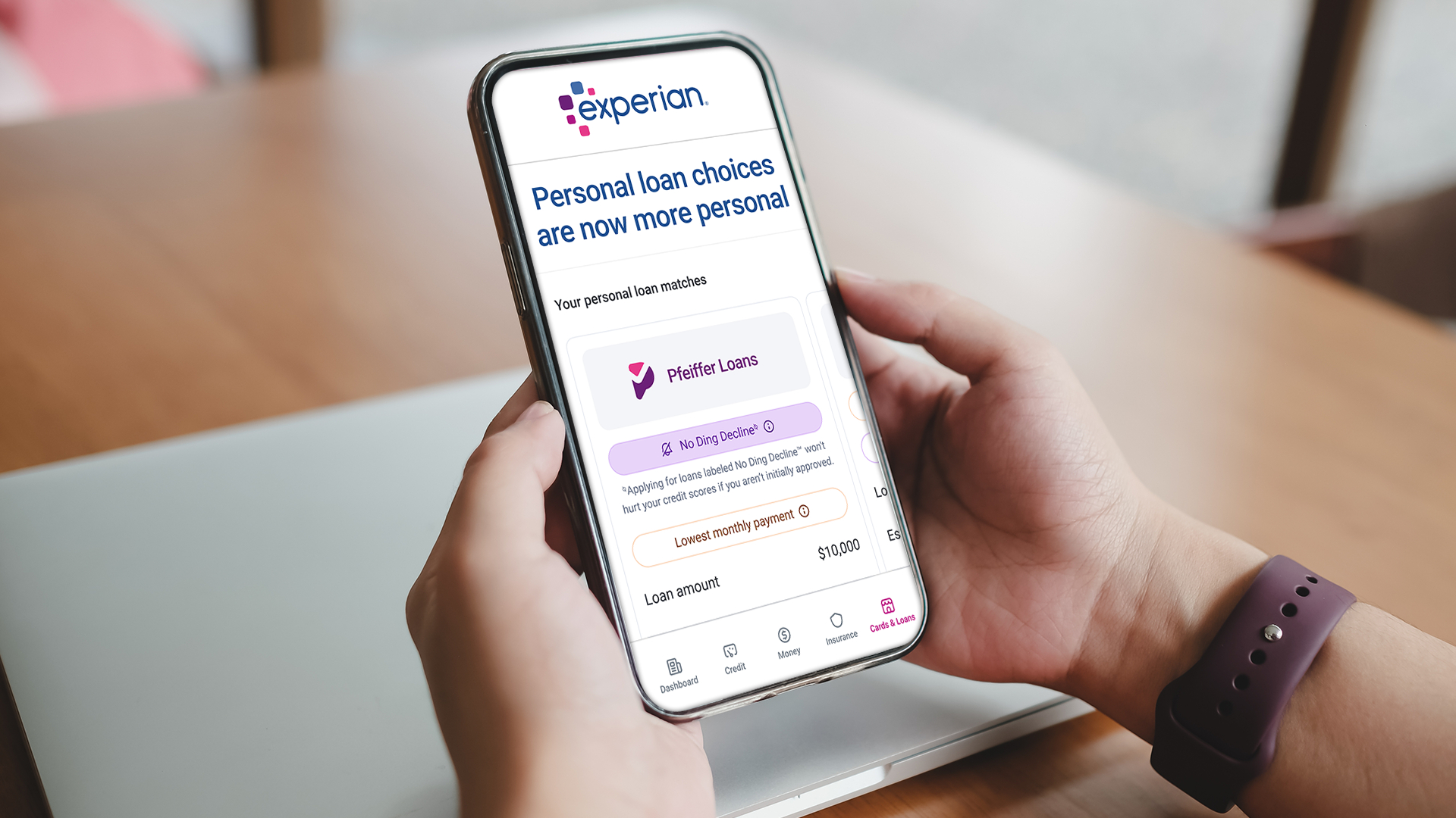 holding a phone with the Experian app