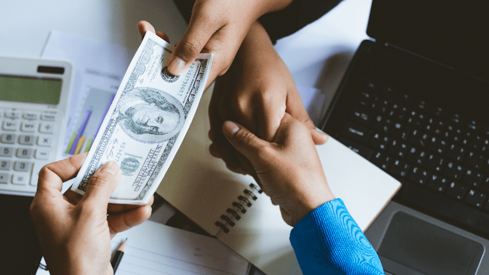 exchanging money over a handshake