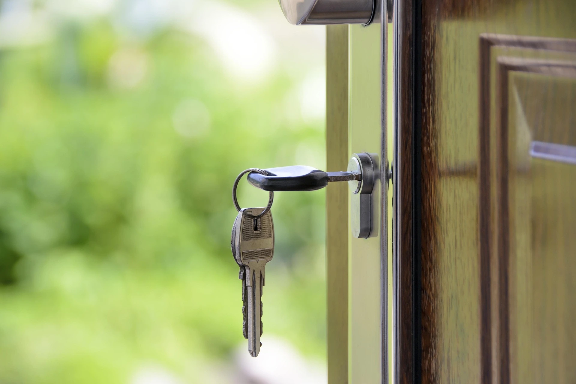 front door of a home with a key in the lock