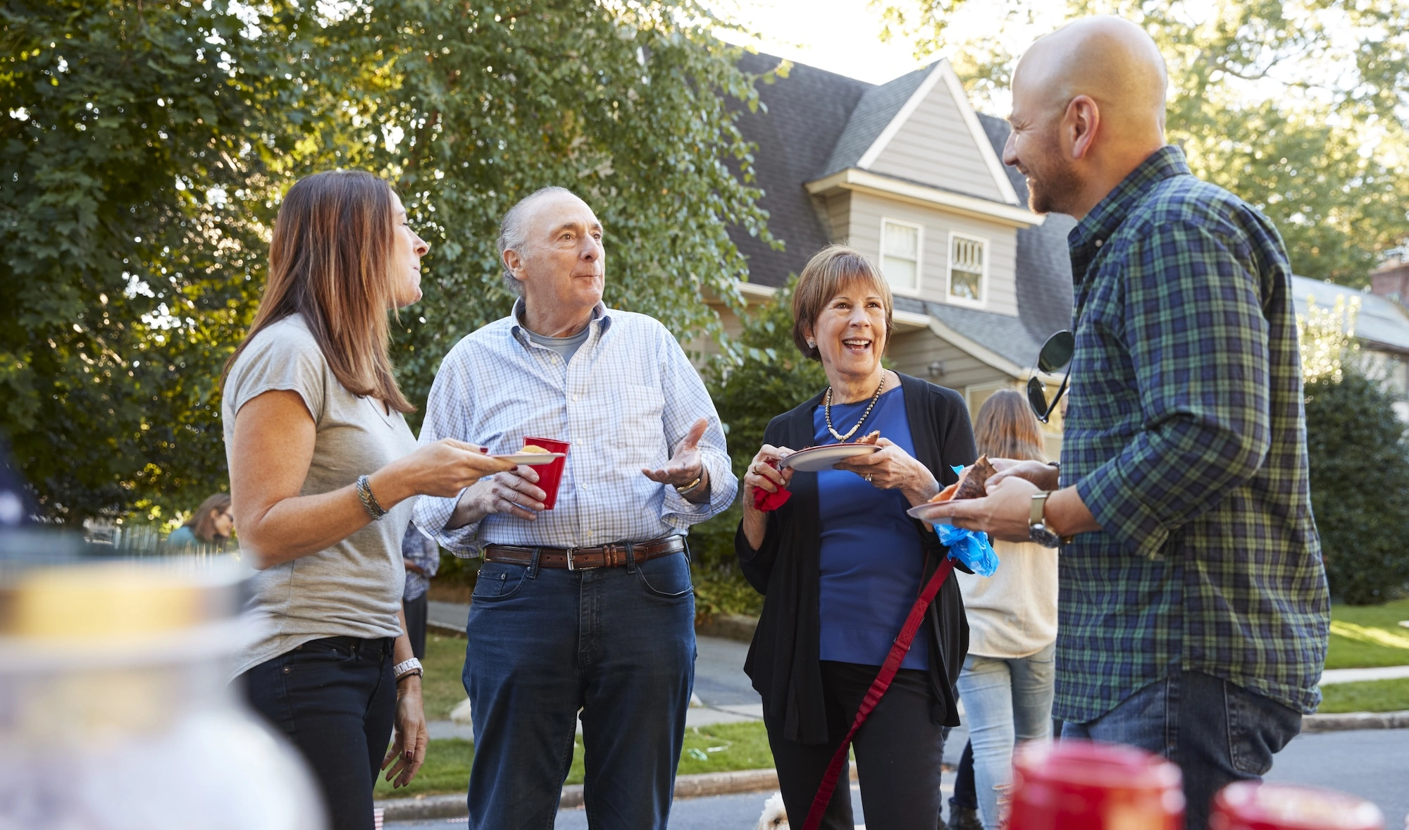 two couples talking in a neighborhood