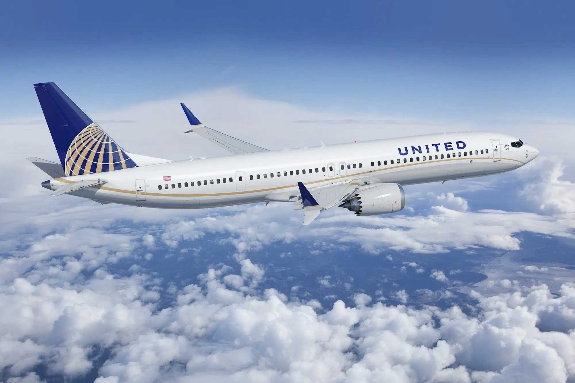 United airplane in the sky with clouds in the background