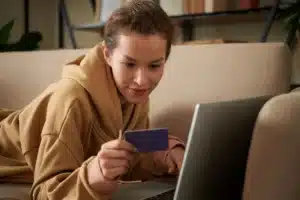 looking at a credit card while working on a computer